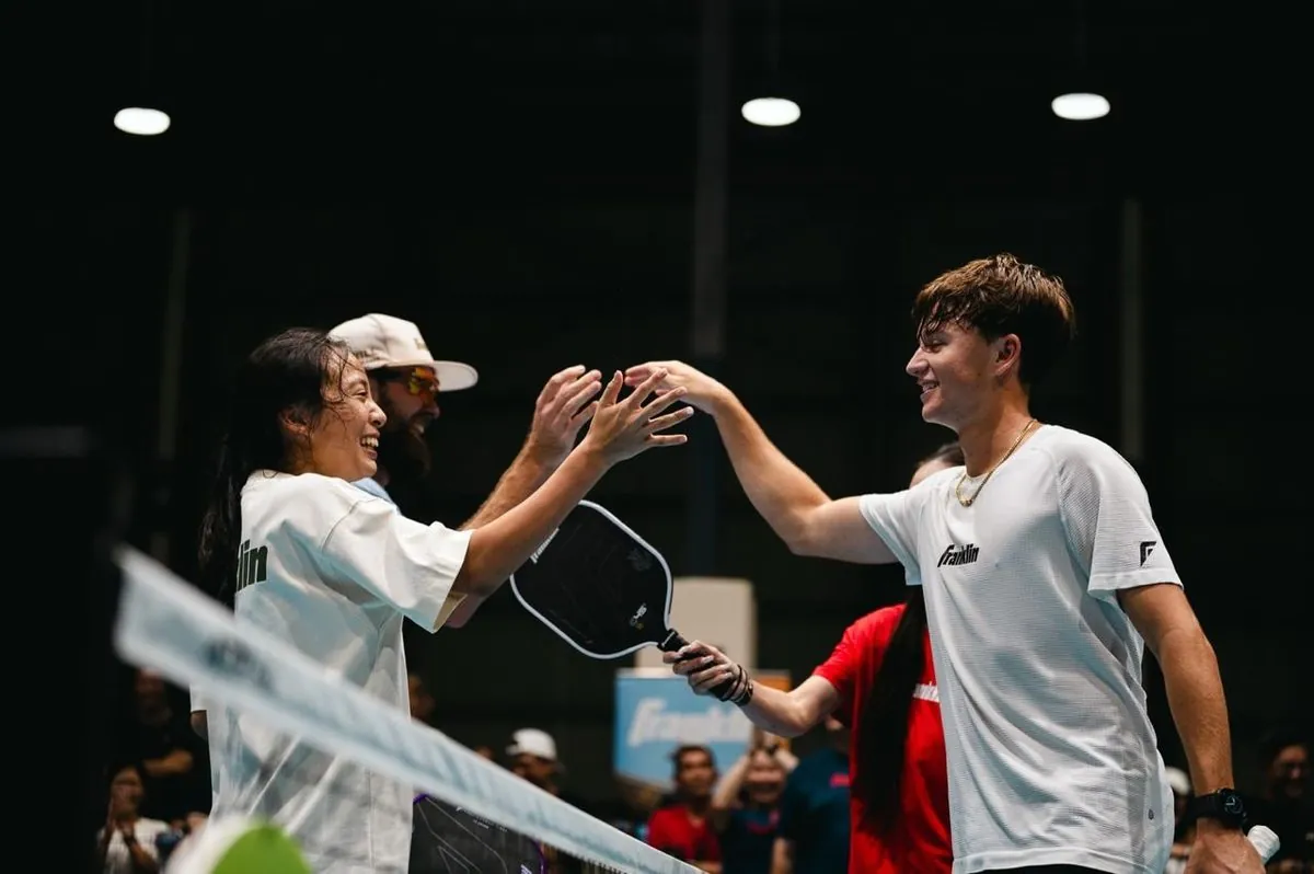 Players sharing a high-five at the net