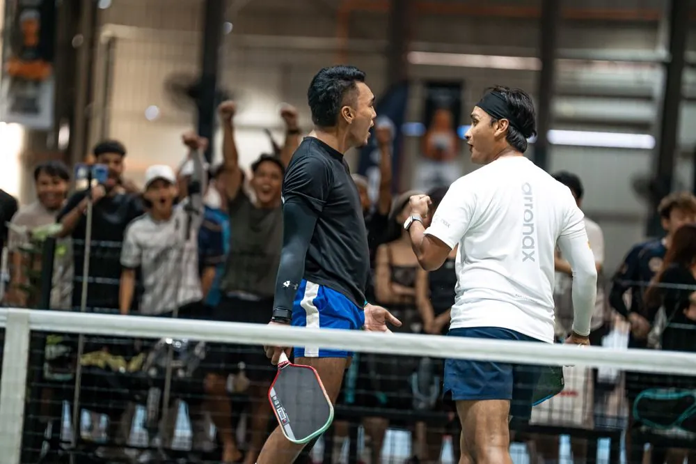 Players fist-bumping after a match at ATP Club